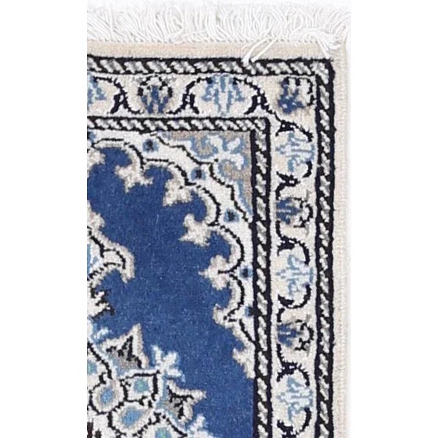 Persian Nain rugs are renowned for their detail and fine use of outlining along the central motifs. Breaking from the...