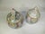A set of 2 studio pottery slip glaze covered jars. These gloss finish jars are taupe in color with a flame slip pattern in...