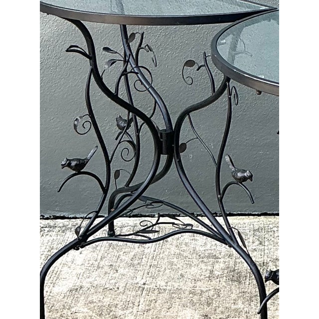 This pair of vintage sculptural metal demilune console tables features distinctive black metal frames with intricate...