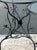 This pair of vintage sculptural metal demilune console tables features distinctive black metal frames with intricate...