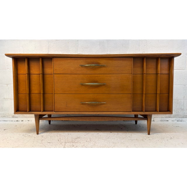 Kent Coffey Furniture manufactured this walnut lowboy dresser in the 1960s at the peak of their popularity in the American...