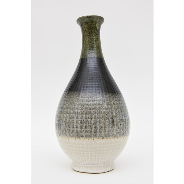 This handsome Italian unsigned glazed large ceramic vessel or vase is in the style of Fantoni. It is from the 90's. There...