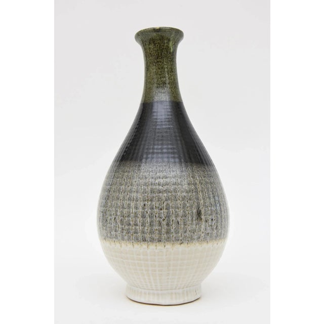 This handsome Italian unsigned glazed large ceramic vessel or vase is in the style of Fantoni. It is from the 90's. There...