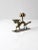 This vintage Chinese brass candlestick holder is crafted in the form of a dragon intertwined with lotus flowers, a...