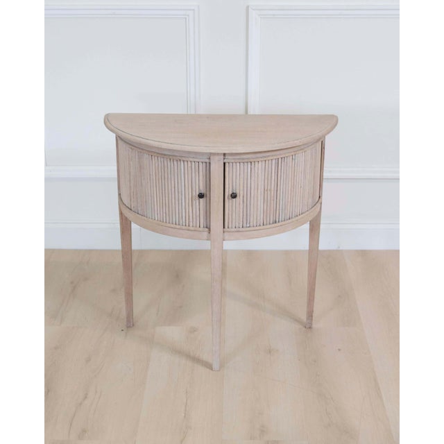 Made in the Netherlands around 1920, this small Dutch demi-lune console table is constructed in bleached oak and fitted...