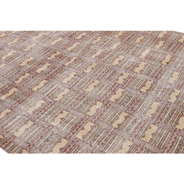 Hand-knotted in wool, this 7x10 vintage rug originating from Turkey, circa 1960-1970, is a very special piece, featuring a...