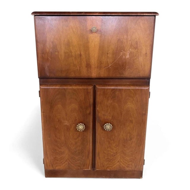 This mid-century drinks cabinet is a striking walnut cocktail bar designed to elevate your home entertaining experience....