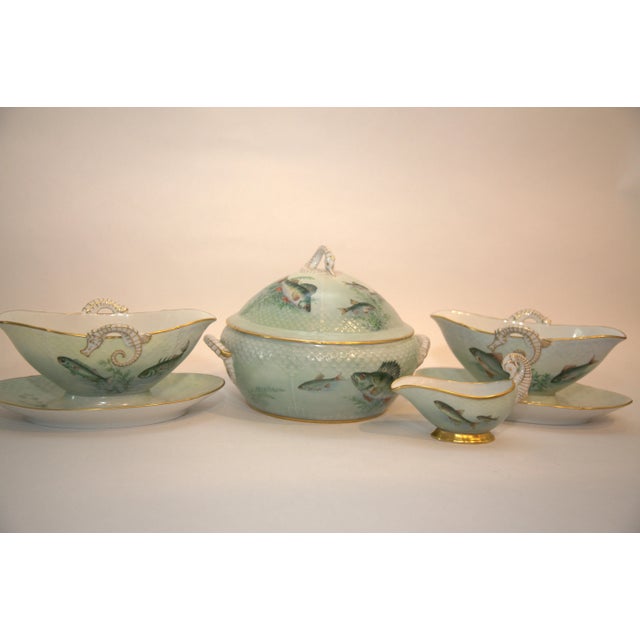 The gold trim on all the pieces is bright and in very good condition. All pieces have textured design looking like fish...