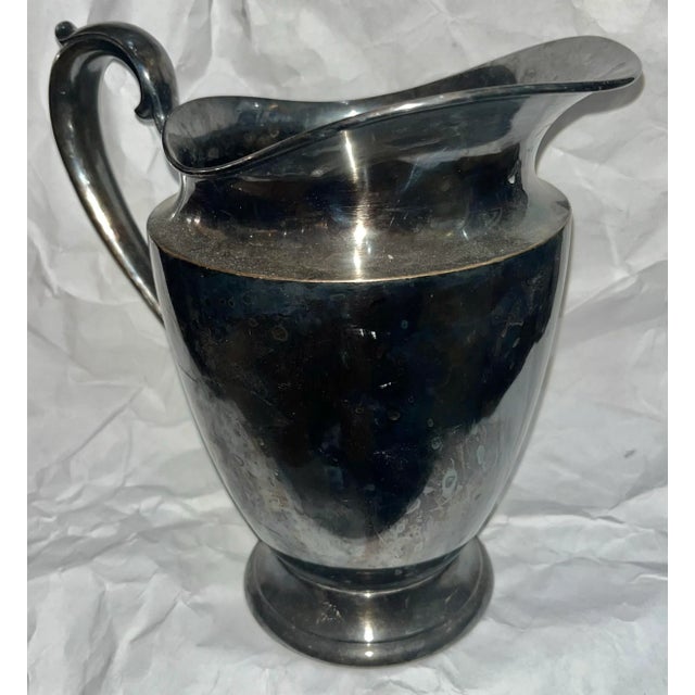 A nice vintage silver water pitcher from International Silver Company marked #527 at bottom. Elegant lines. Needs polishing.