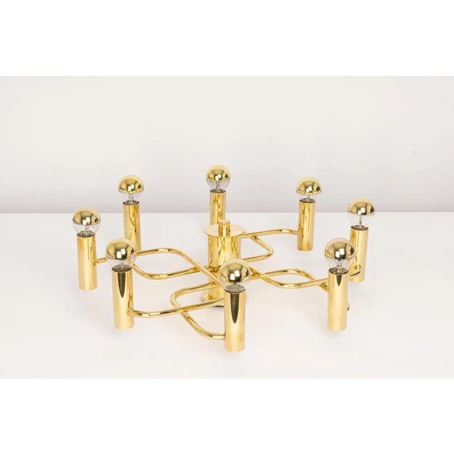 Stunning eight-light brass chandelier, in the style of designer sciolari in the 1970s. Great geometrical shape. Very good...