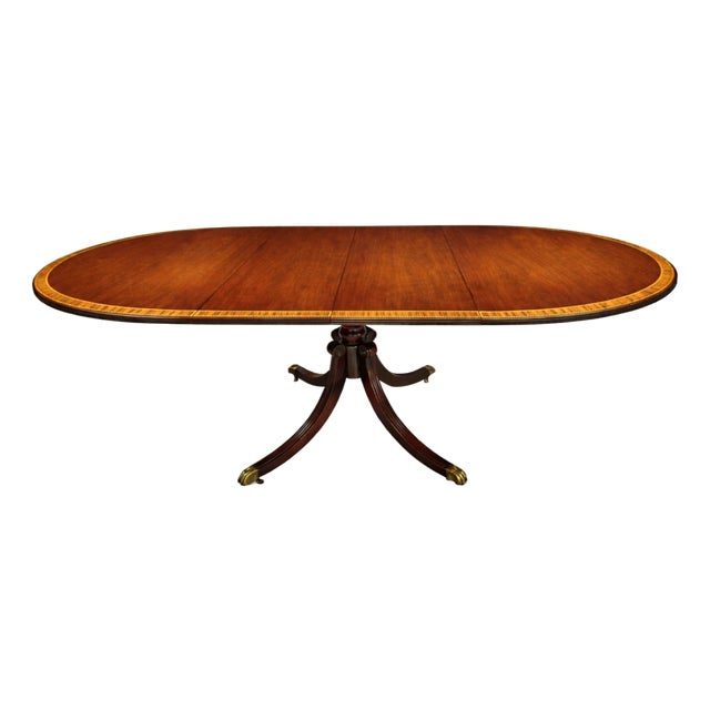 English Regency Revival Flame Mahogany Oval Extension Dining Table With Satinwood Crossbanding and Brass Paw Feet, Circa 1935 For Sale