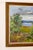 Realistic oil painting on panel featuring a serene landscape with water and trees. Dimensions: 61 x 71 cm. Signed Nystad...
