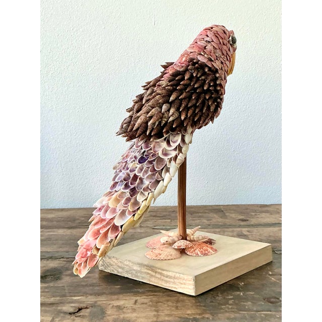 Elevate your coastal or bohemian interior with this enchanting vintage shell-encrusted bird sculpture. Meticulously...
