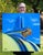 The artwork depicts the iconic hood ornament of a Pontiac Chieftain, rendered with vibrant blues and golds that evoke a...