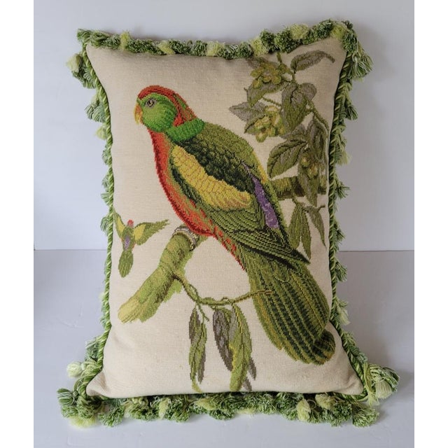 Fabulous wool needlepoint down and feather filled pillow of a colorful green parrot on a branch. Pillow is bordered with...