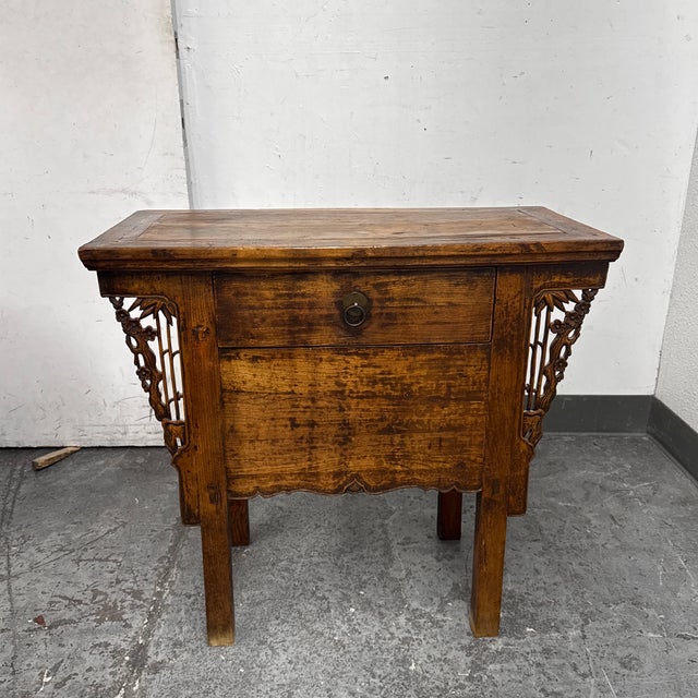 Design Plus Gallery presents a 19th Century Chinese Elmwood Altar Table. This antique elmwood altar table has a...