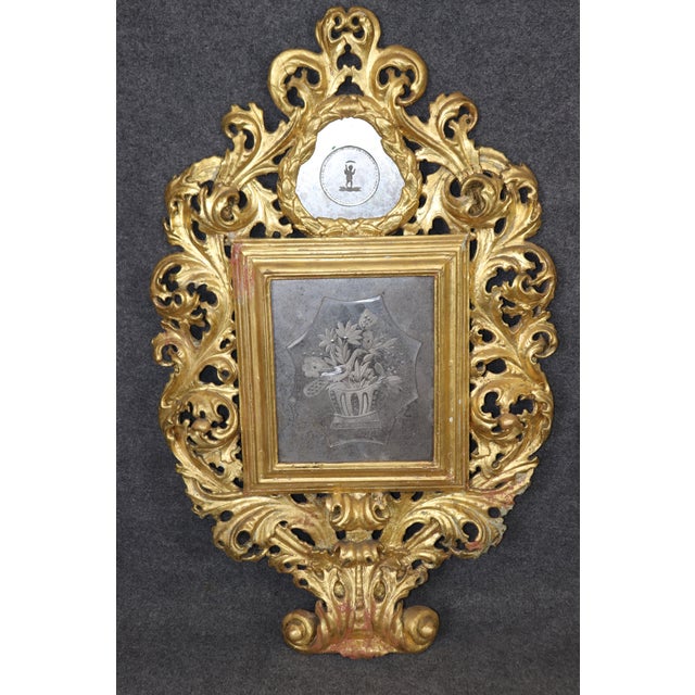 This large pair of Florentine Italian gilded Rococo mirrors exudes the opulence and artistry of 18th-century design,...