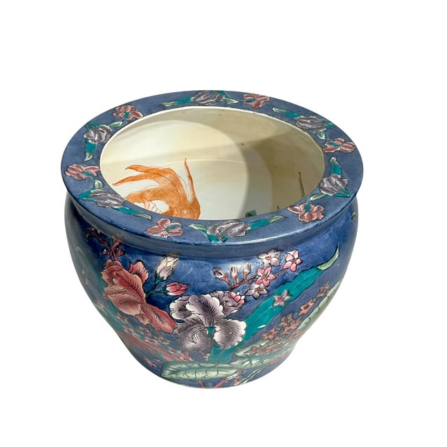 A striking vintage Chinese fish bowl or cachepot featuring a richly saturated purple/blue ground adorned with vibrant...