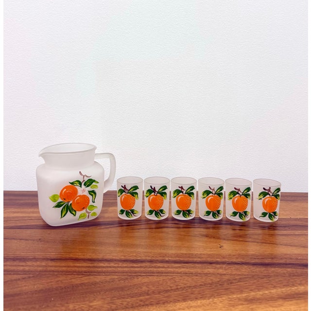 Charming vintage frosted glass beverage set consisting of a matching pitcher and six tumblers, each decorated with vibrant...