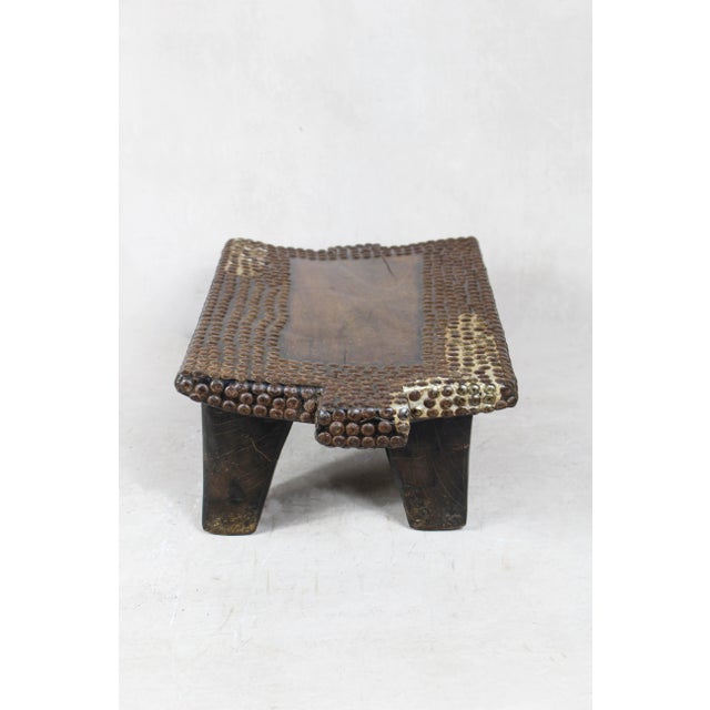 This carved vintage stool is a stunning piece of traditional African craftsmanship. Hand-carved from solid wood, it...