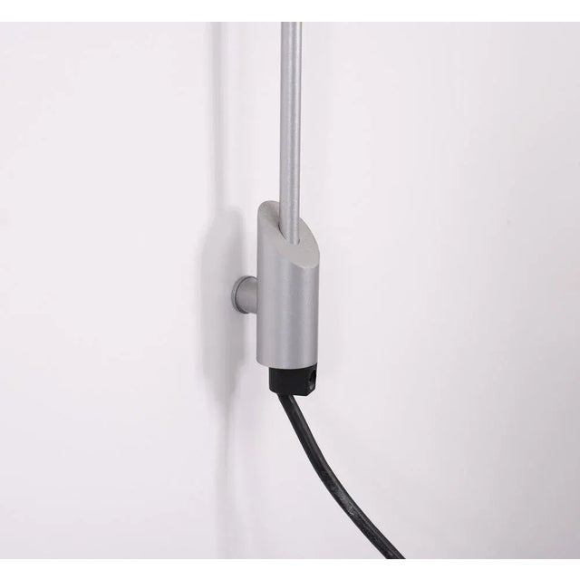 Very unusual high torchier. Sleek Grey metal upright, in the middle a chrome bal where the lamp is hold by a simple wall...