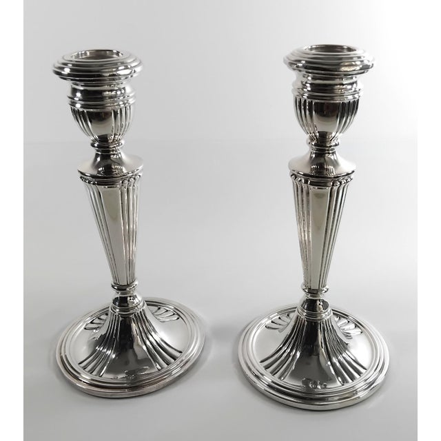 A striking and elegant pair of mid-century sterling silver candlesticks, masterfully crafted in Spain during the 1950s....