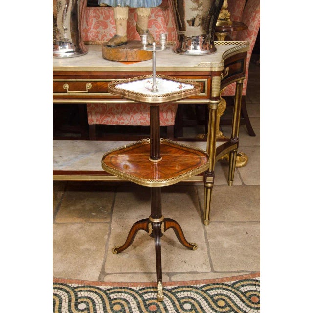 A fine French kingwood inlaid luminaire with two lights, pierced bronze galleries, porcelain inlaid plate, fluted pedestal...