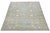 This hand-knotted wool rug has a light blue background adorned with brown and yellow accents in an all-over design. This...