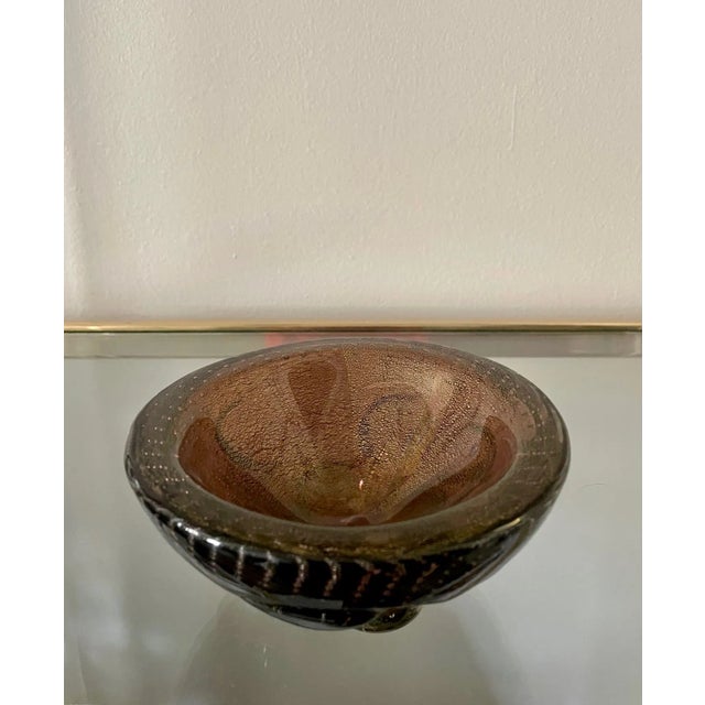 A small but hefty mid-century Murano bowl with undulating protrusions on the exterior filled with a ton of tiny bubbles....