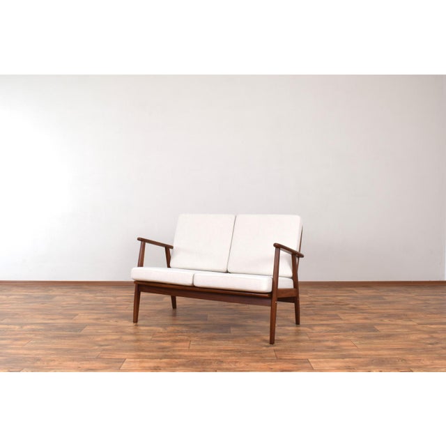 This sofa was manufactured in Denmark in the 1960s. The frame is made of solid teak and has been professionally and...