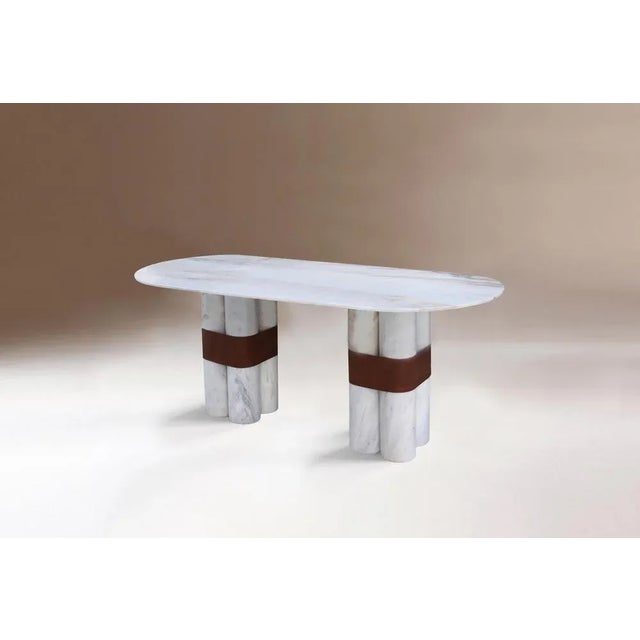 Axis oval table by Dovain Studio Dimensions: H 79 x Ø 200 cm. Materials: Estremoz white marble, eco leather. Dovain Studio...