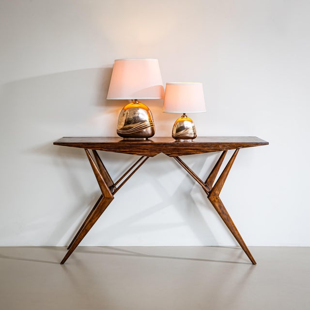 Library table with a distinctive tapering base featuring characteristic sculptural supports, a rectangular top, and an...