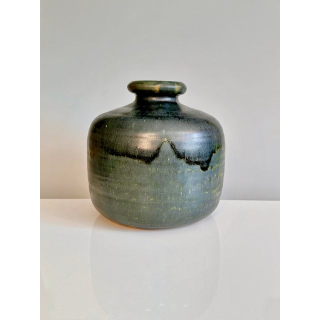 Handcrafted and signed ceramic vase by Hubertus Menzel with an organic, sculptural form and characteristic flowing glaze...