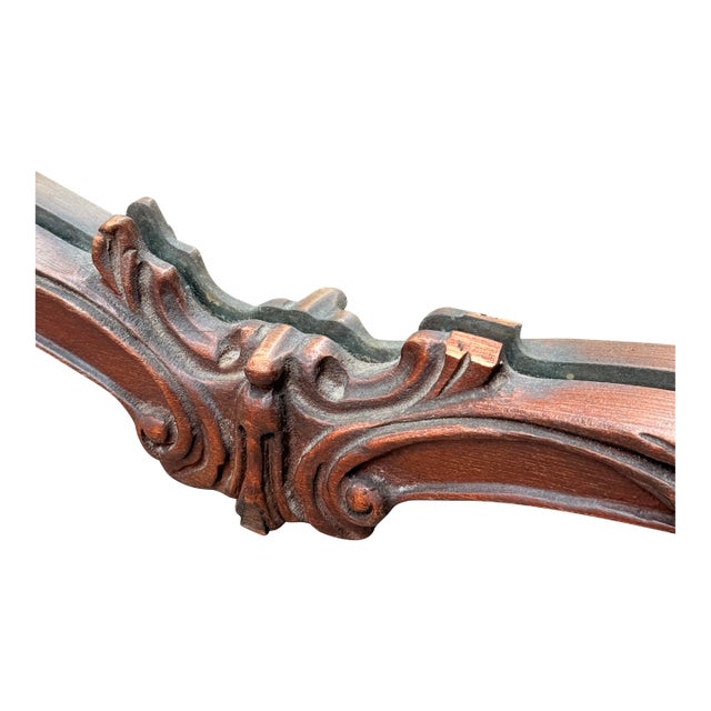 Vintage French Rococo Louis XV style wall or mantel mirror crafted with a carved mahogany frame featuring an ornate...