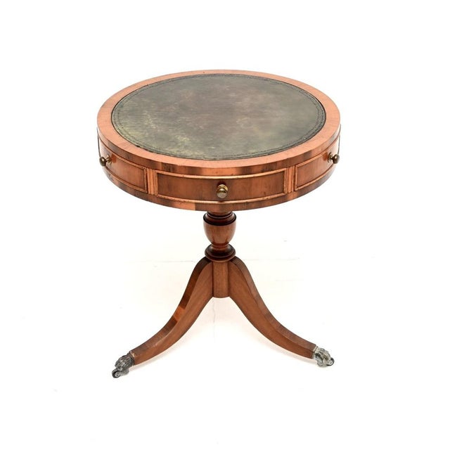 A lovely antique yew wood leather top drum table in the Regency style. This was made in England, it dates from around the...
