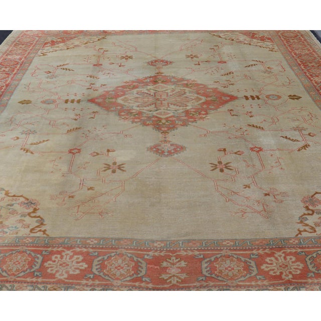 Large antique Turkish Oushak rug in light green background and coral border. Keivan Woven Arts / rug N15-1002, country of...