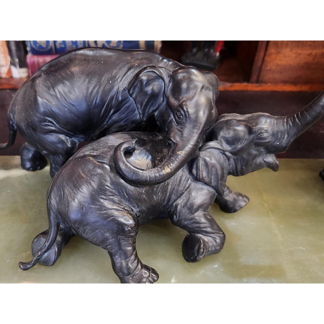 Beautiful green onyx and brass elephant ink well. There are two brass elephants atop the onyx. On each side is an ink well...