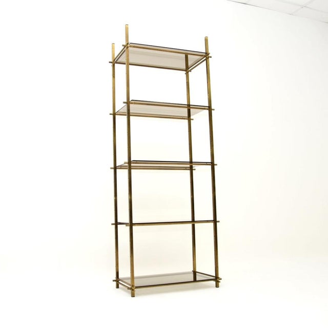 An extremely stylish and very well made vintage French brass etagere display cabinet. This was made in France, it dates...