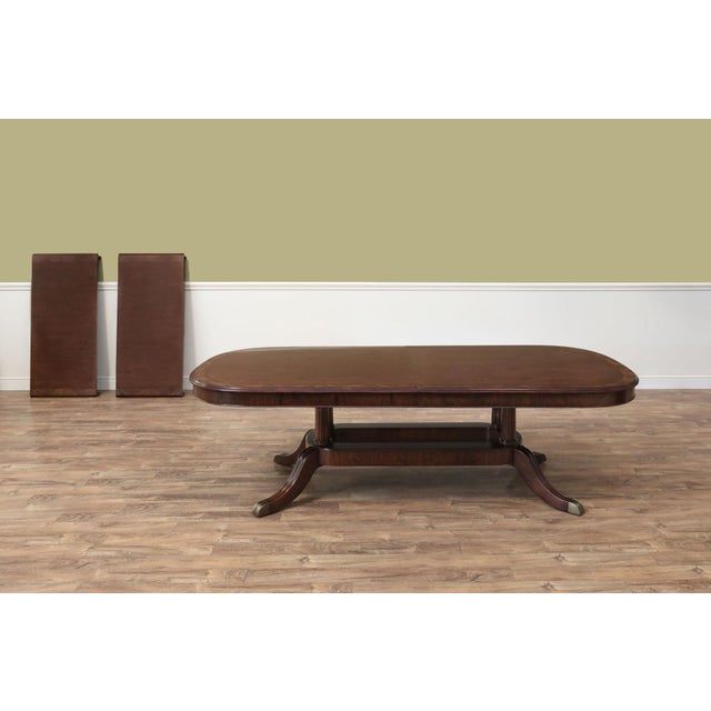 Extending dining room table by Theodore Alexander and Stephen Church, the Wayborne Table. This table comes with two 24"...
