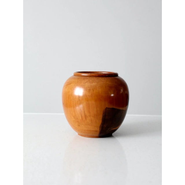 This vintage wooden vase features a hand-crafted southwestern scene with a donkey and mountain landscape in deep brown...
