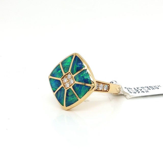 This authentic Kabana fire opal inlay and diamond ring is crafted in rich 14k yellow gold and features a vibrant fire opal...