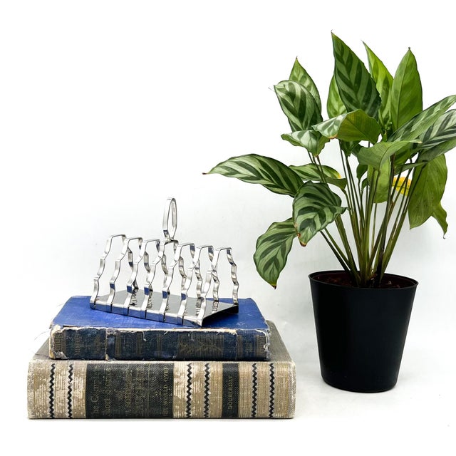 Brilliant, English stainless steel six-slice toast rack by Olde Hall, featuring a hammered base and six sculptural...