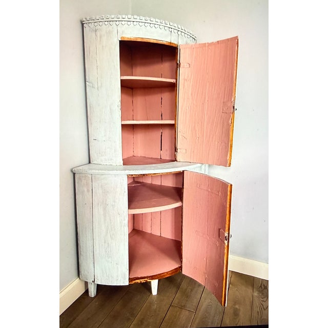 What a wonderful piece of furniture! An original pine corner cabinet from around 1800. The interior, including the...