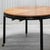 Elliptical dining table by Michael Taylor for Baker (unmarked), book matched wood grain top, with black lacquered base and...