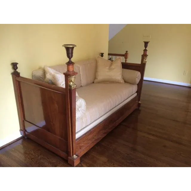 Rare antique empire mahogany daybed with bronze accented caryatids. The original wheels allow for easy re-locating in a...