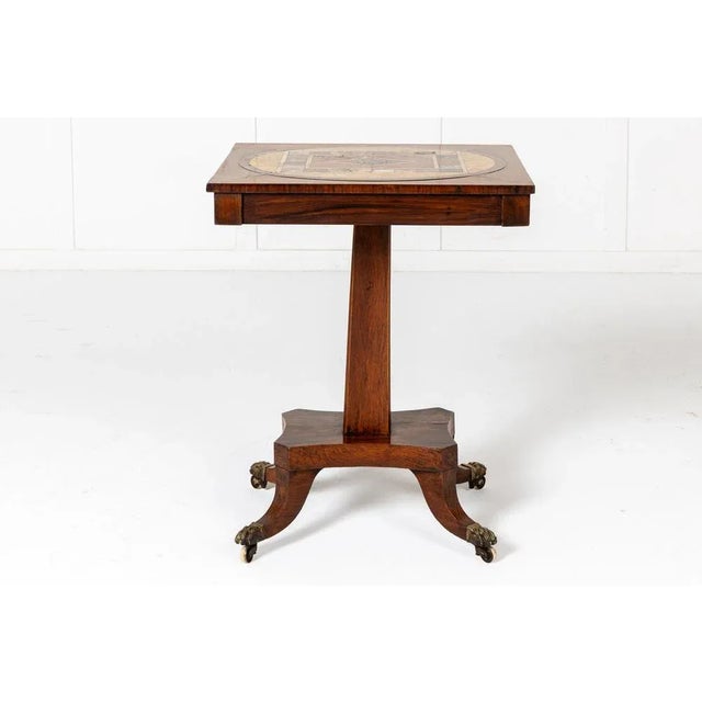 A 19th Century English Regency Rosewood and Faux Rosewood Table with Specimen Marble Top. This interesting table has a...