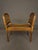 A charming 19th-century French Louis XVI-style bench featuring a gilded finish, a hand-carved wooden frame, a cane seat,...