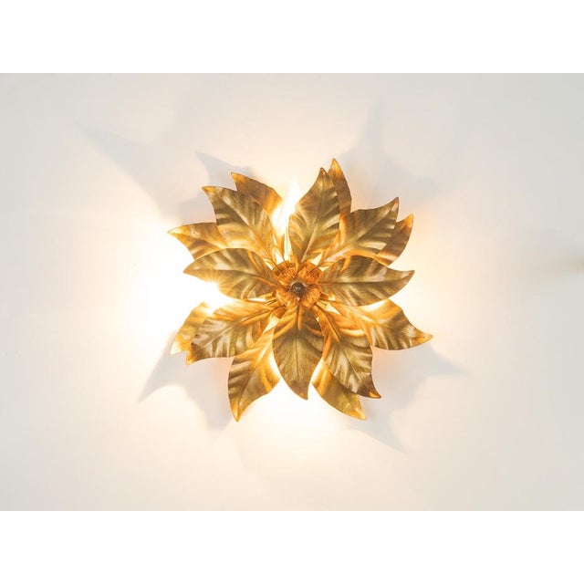 A wonderful 1970s Hollywood Regency-style ceiling lamp by Hans Kögl. It features a high-quality, gold-colored leaf-shaped...