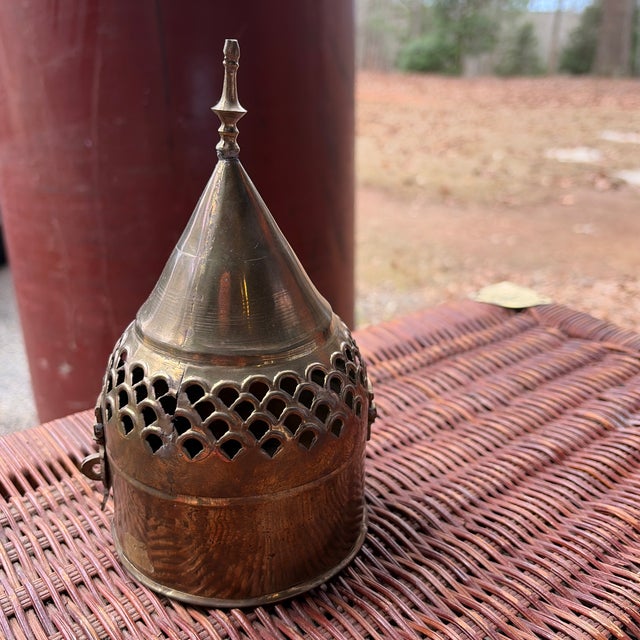 Vintage pierced brass decorative container with a sculptural domed lid and finial top. Featuring hand-cut scalloped...