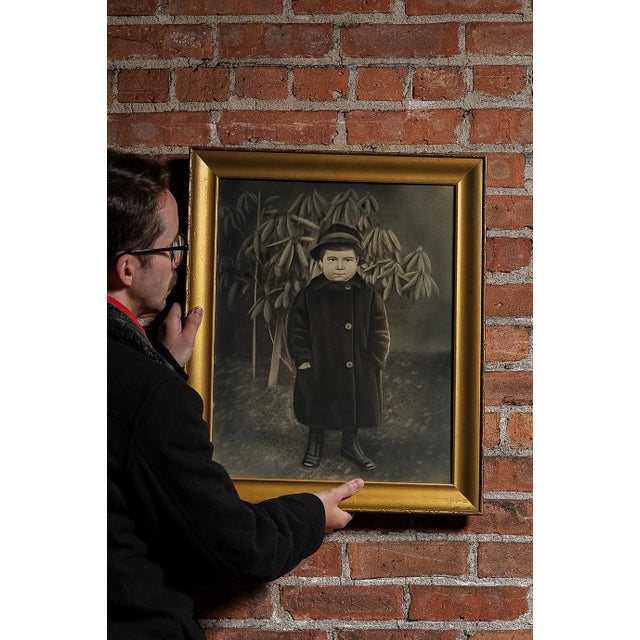 An early illustration of a child, done in charcoal and framed in a gilt-painted wooden frame. This piece measures 19.75"W...